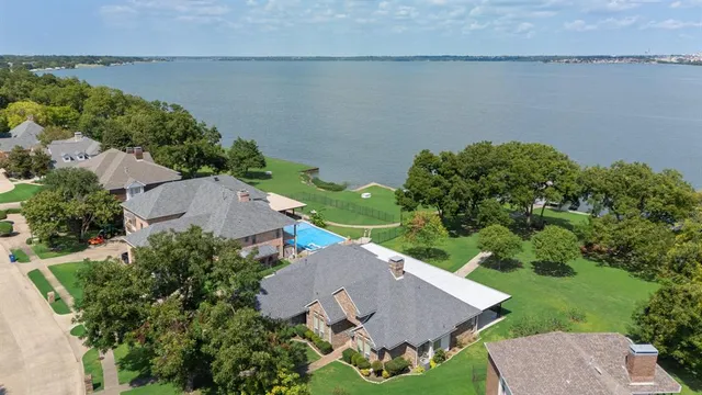 an aerial view of a house with outdoor space and lake view