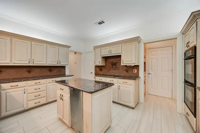 a kitchen with a sink stove and cabinets