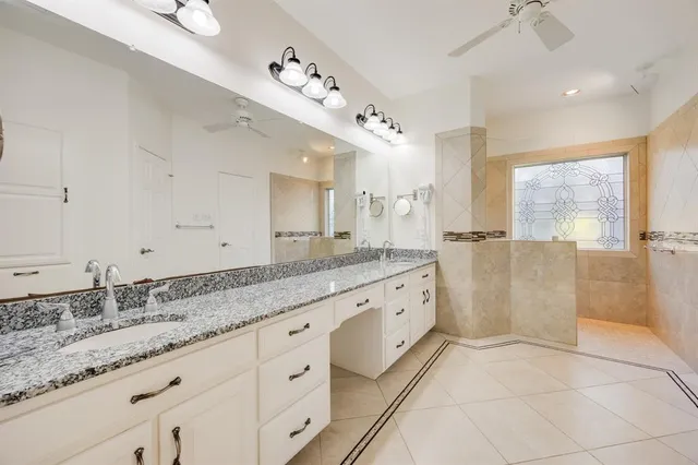 a bathroom with a tub sink and mirror