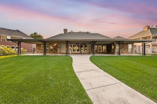 a front view of a house with a garden and yard