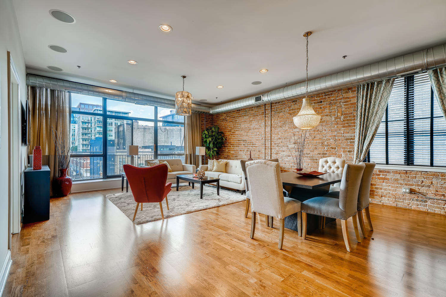 23 North Green Street, Unit 401 Chicago, IL 60607 - Photo 2 of 17 a living room with furniture and a large window