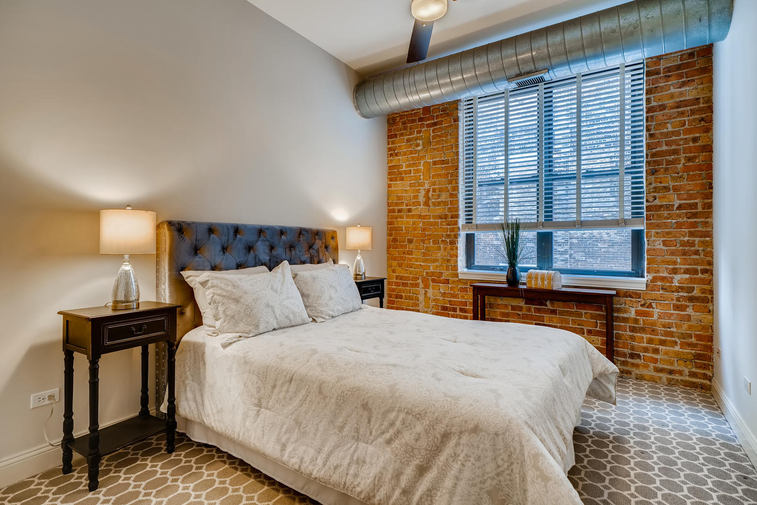 23 North Green Street, Unit 401 Chicago, IL 60607 - Photo 12 of 17 a bed sitting in a bedroom next to a window