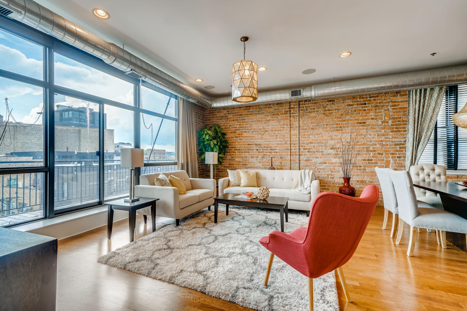 23 North Green Street, Unit 401 Chicago, IL 60607 - Photo 3 of 17 a living room with patio furniture and a large window