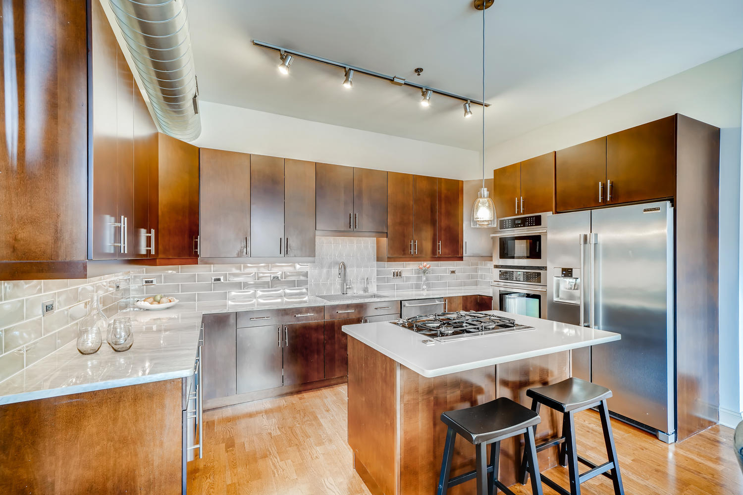 23 North Green Street, Unit 401 Chicago, IL 60607 - Photo 5 of 17 a kitchen with kitchen island a counter top space appliances and cabinets