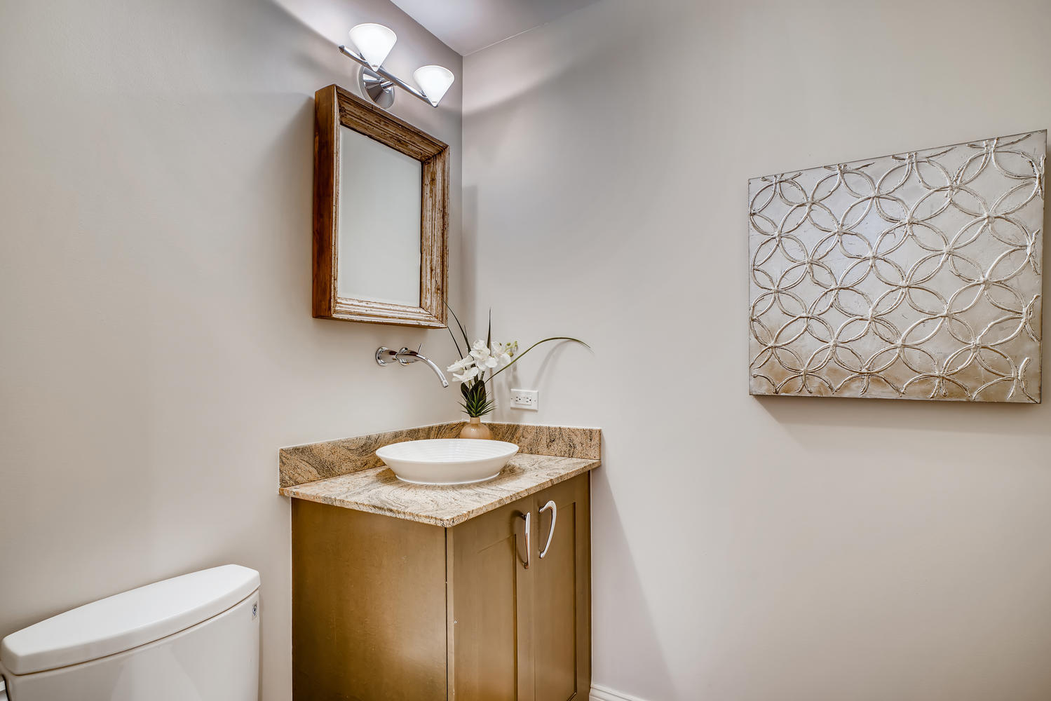 23 North Green Street, Unit 401 Chicago, IL 60607 - Photo 6 of 17 a bathroom with a sink a toilet and mirror