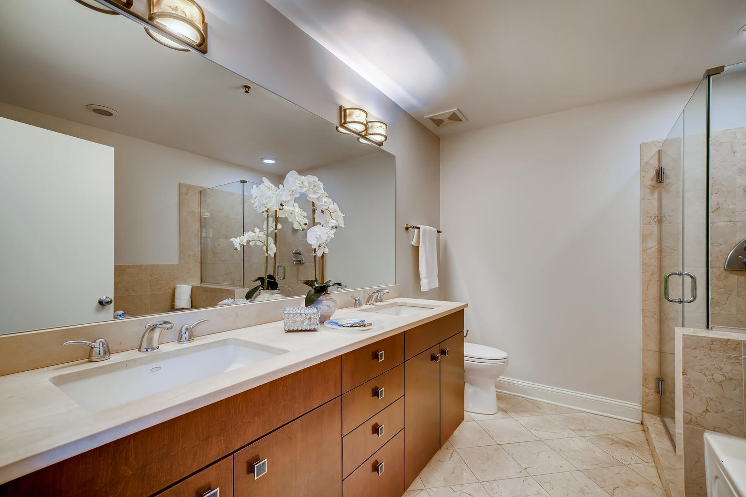23 North Green Street, Unit 401 Chicago, IL 60607 - Photo 9 of 17 a bathroom with a sink double vanity granite and a mirror