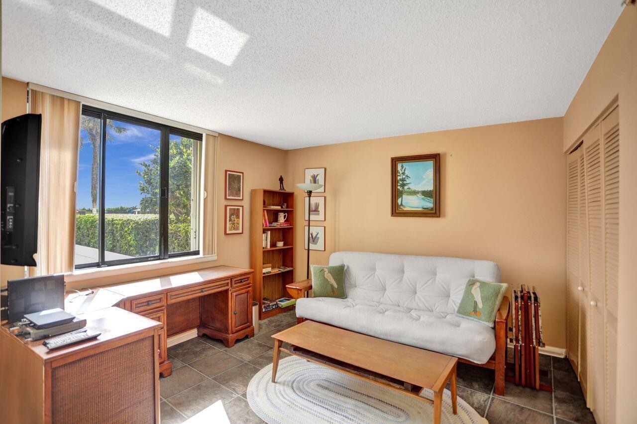 100 Ocean Trail Way, Unit 109 Jupiter, FL 33477 - Photo 9 of 27 a living room with furniture and a window
