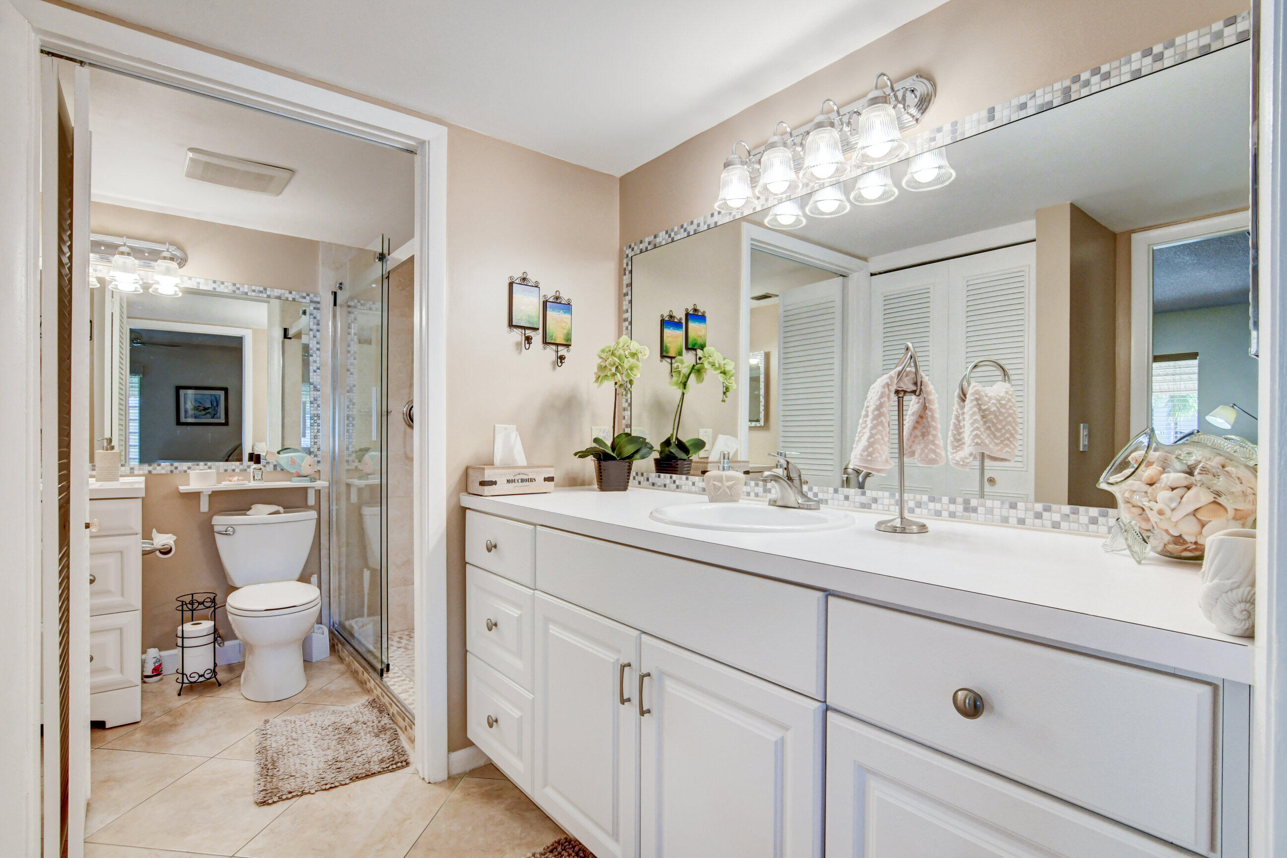 334 Pine Ridge Circle, Unit B1 Greenacres, FL 33463 - Photo 14 of 26 a spacious bathroom with a double vanity sink mirror and toilet