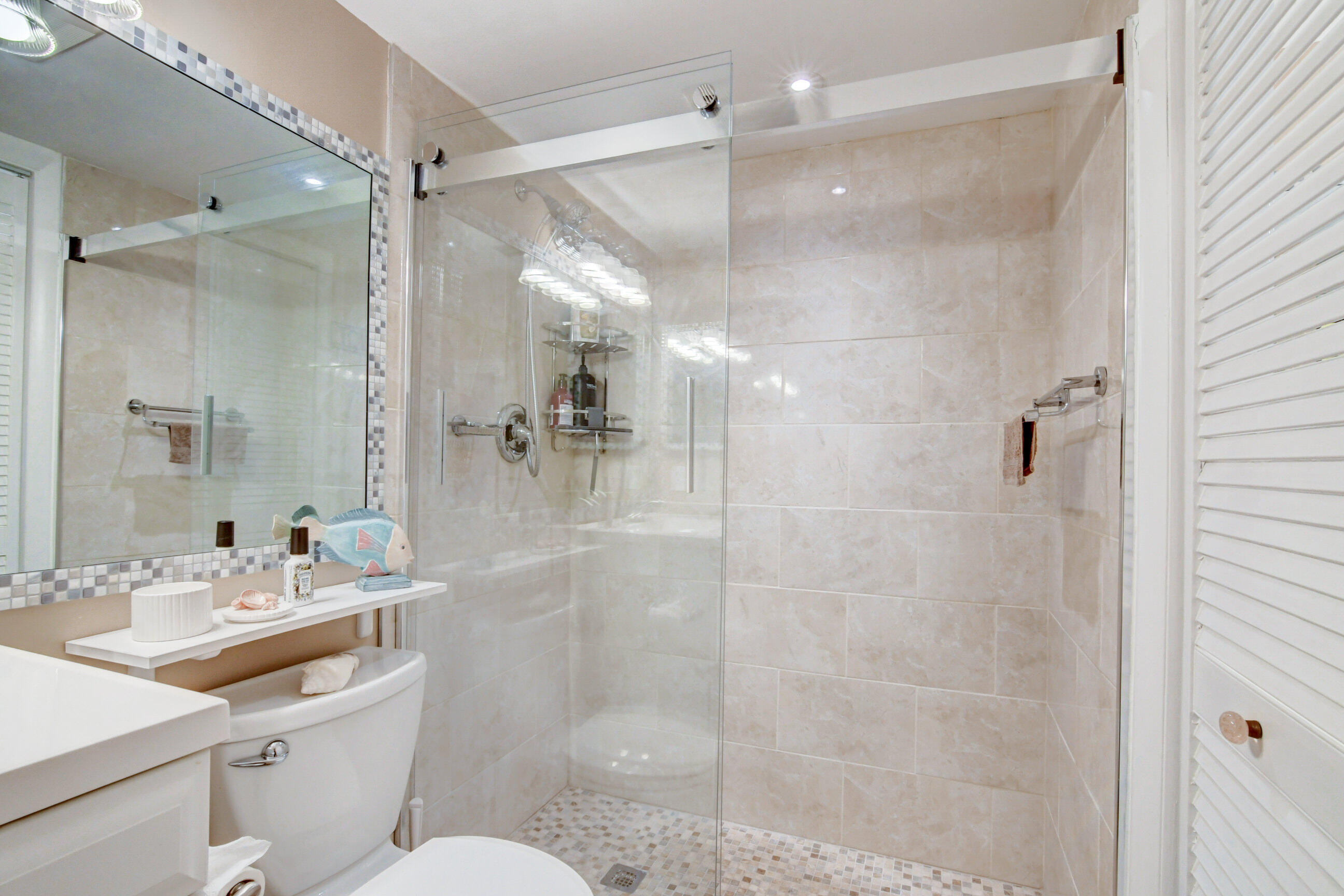 334 Pine Ridge Circle, Unit B1 Greenacres, FL 33463 - Photo 16 of 26 a bathroom with a sink shower mirror and toilet