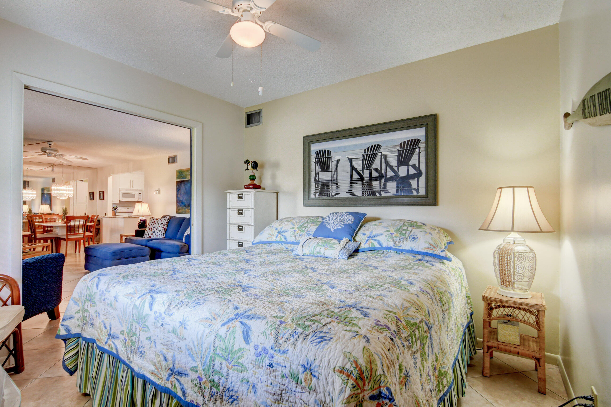 334 Pine Ridge Circle, Unit B1 Greenacres, FL 33463 - Photo 18 of 26 a bedroom with a bed and a chandelier