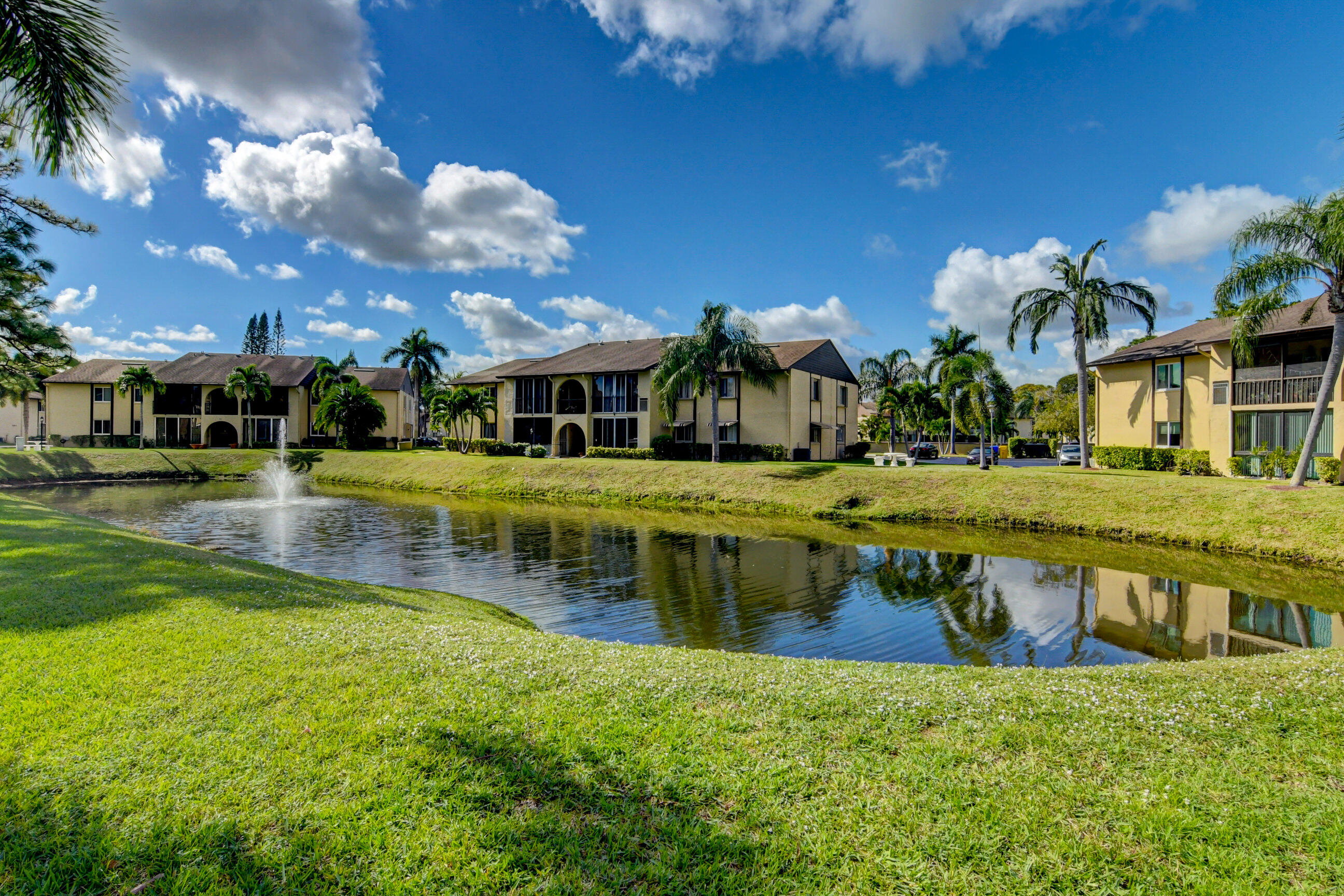 334 Pine Ridge Circle, Unit B1 Greenacres, FL 33463 - Photo 20 of 26 a view of a house with a yard