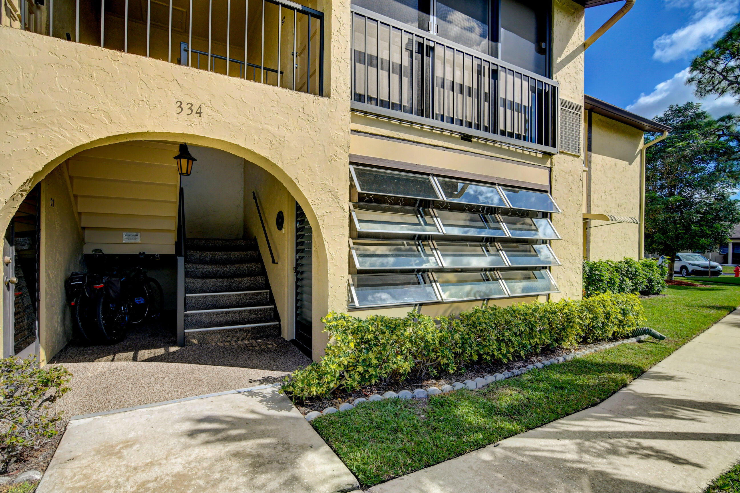 334 Pine Ridge Circle, Unit B1 Greenacres, FL 33463 - Photo 2 of 26 a view of a house with a yard