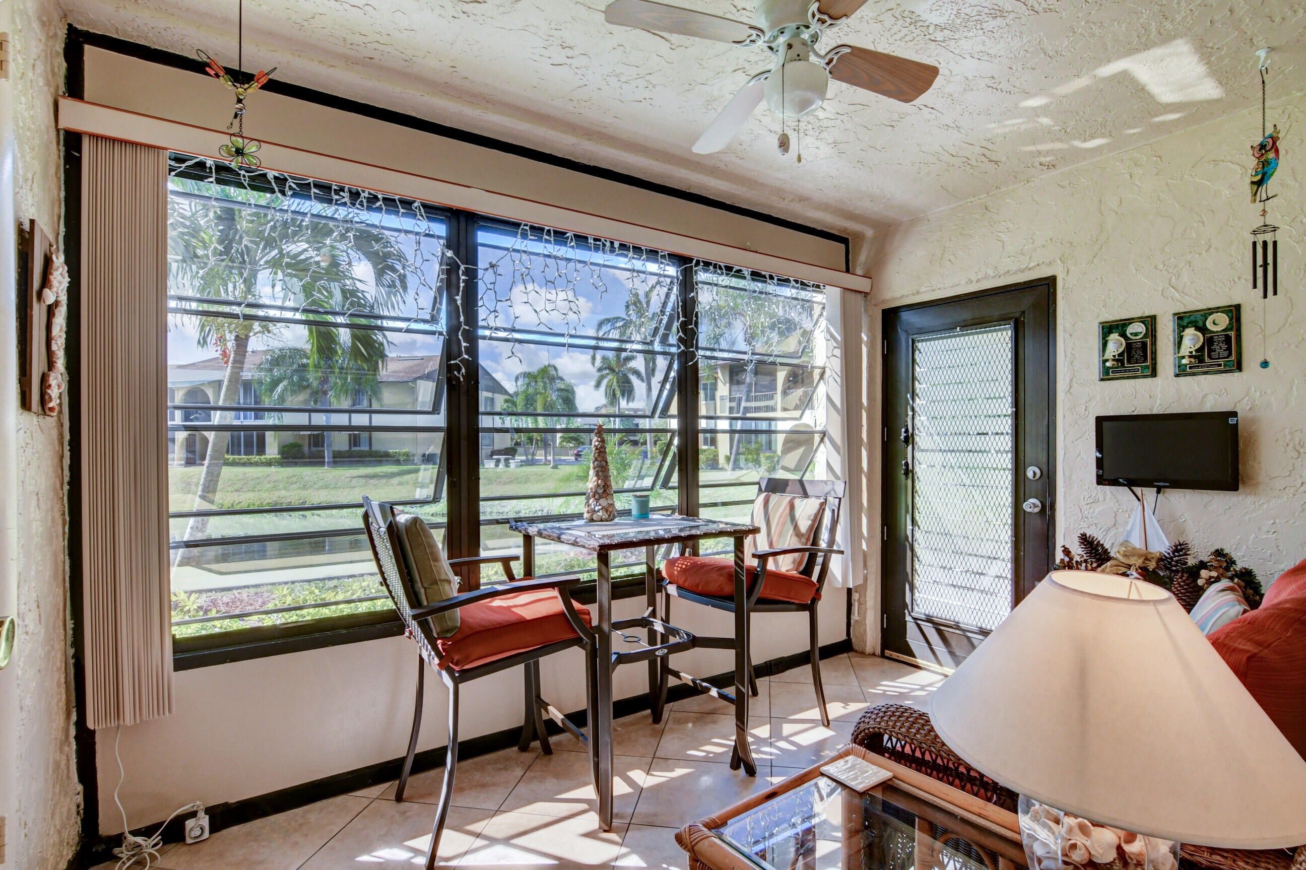 334 Pine Ridge Circle, Unit B1 Greenacres, FL 33463 - Photo 3 of 26 a living room with furniture and a flat screen tv
