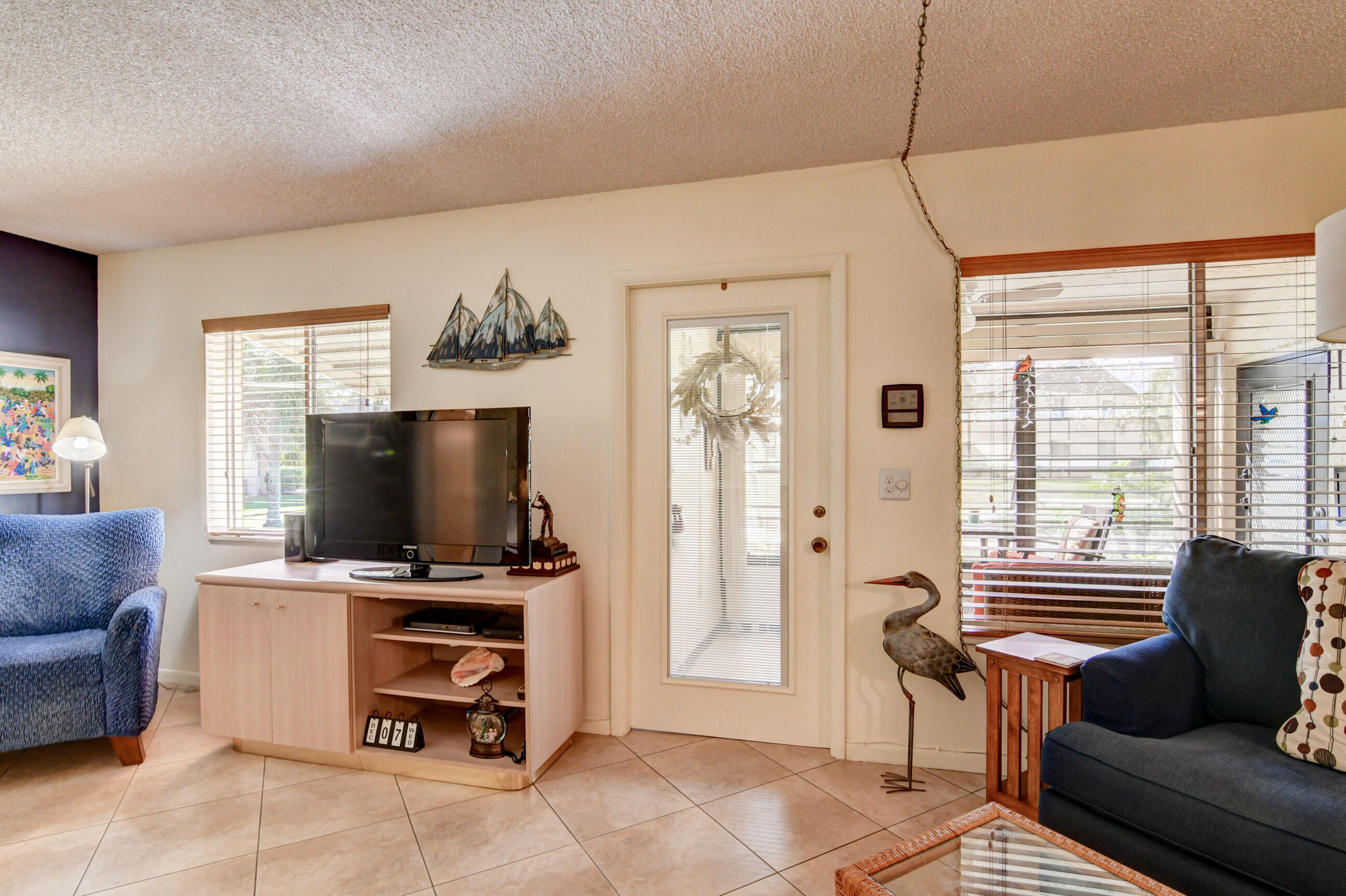 334 Pine Ridge Circle, Unit B1 Greenacres, FL 33463 - Photo 5 of 26 a living room with furniture and a flat screen tv