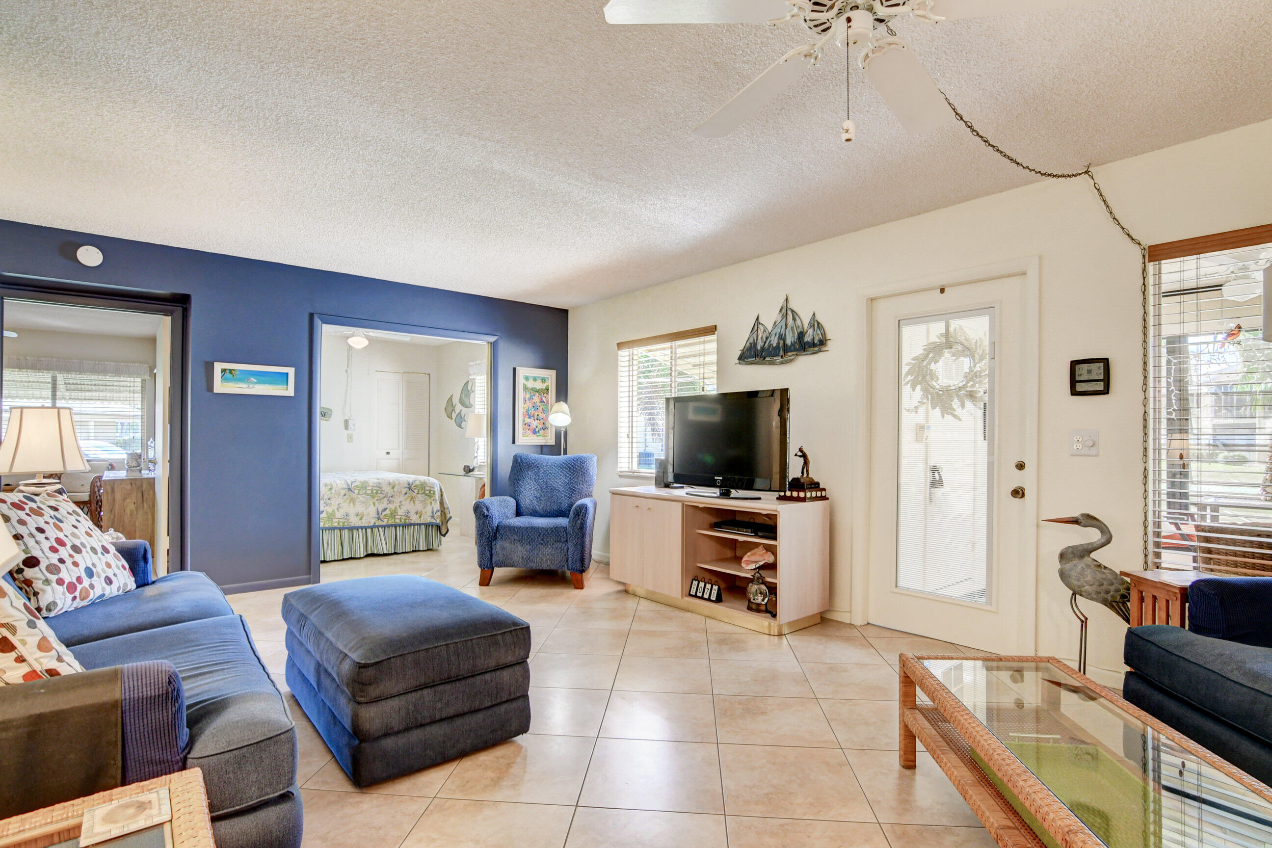 334 Pine Ridge Circle, Unit B1 Greenacres, FL 33463 - Photo 7 of 26 a living room with furniture and a flat screen tv