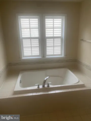 a white bath tub sitting next to a window