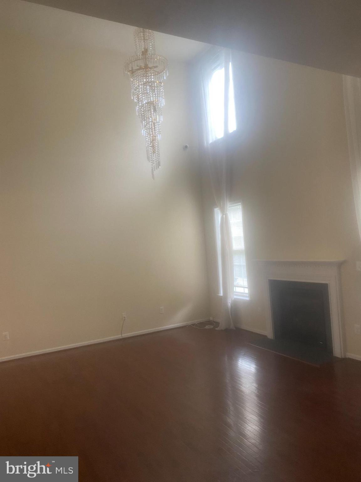 9509 Manor Oaks View Upper Marlboro, MD 20772 - Photo 16 of 20 an empty room with wooden floor and windows
