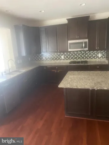 a kitchen with kitchen island sink and stove
