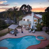 a swimming pool with outdoor seating and garden