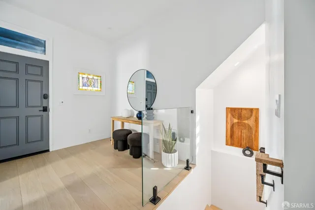 a view of entryway and hall with wooden floor