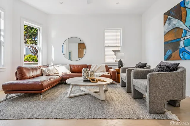 a living room with furniture a rug and a window