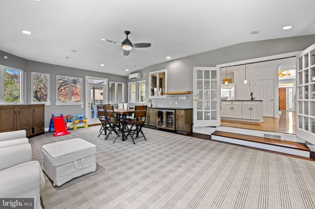 a living room with furniture and large windows