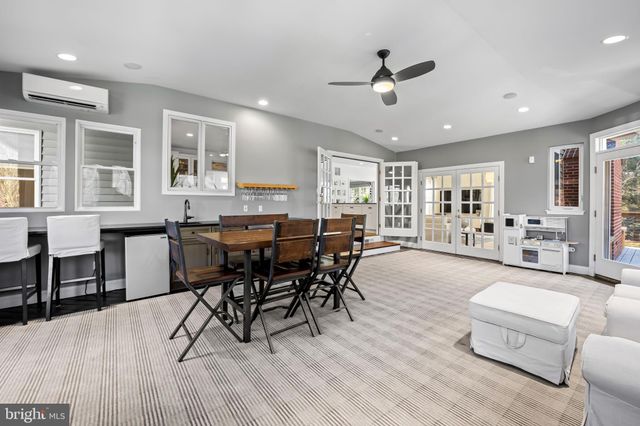 a bathroom with a granite countertop sink toilet and mirror