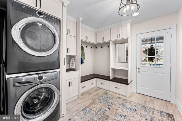 a spacious bedroom with a bed a dresser and a flat screen tv