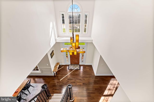a bathroom with a granite countertop sink a mirror and a shower