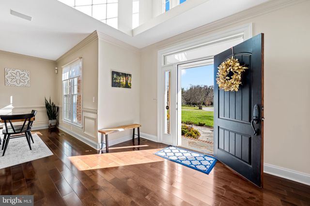 a view of entryway and dining room with wooden floor