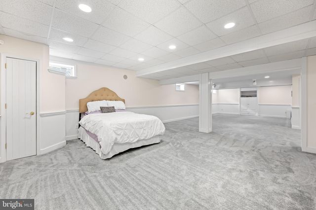 an aerial view of a house with a yard basket ball court and outdoor seating