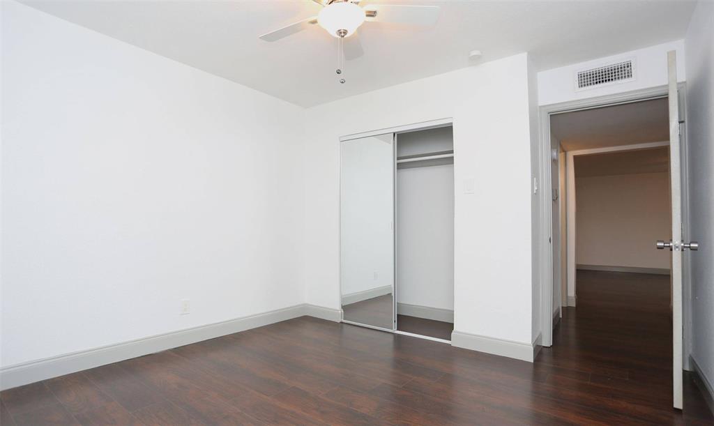 404 East 9th Street, Unit 8102 Dallas, TX 75203 - Photo 12 of 15 an empty room with wooden floor and closet