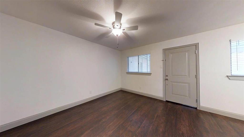404 East 9th Street, Unit 8102 Dallas, TX 75203 - Photo 5 of 15 a view of an empty room with wooden floor and a window