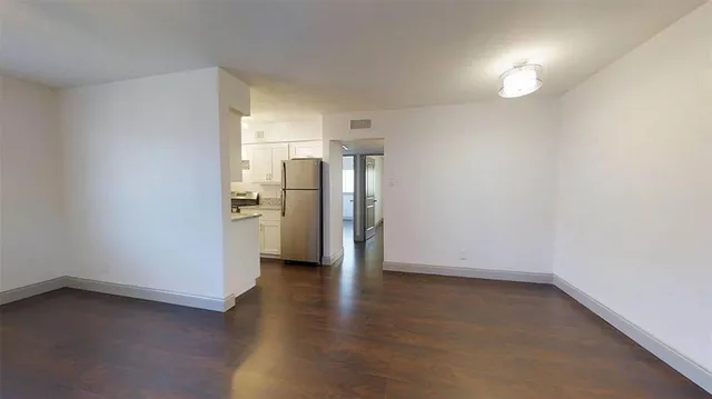 a view of a kitchen with a sink and refrigerator