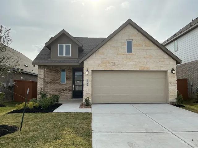 a front view of a house with garage