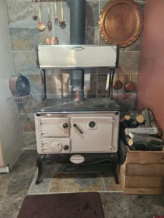 a stove top oven sitting inside of a kitchen