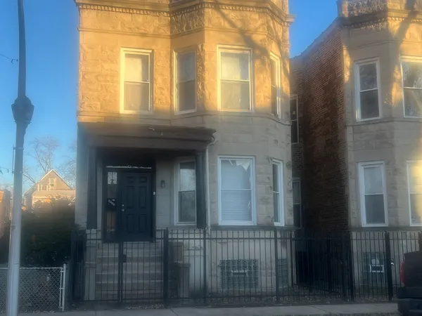 a view of a brick house with many windows