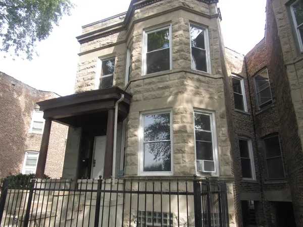 a view of a brick building next to a yard