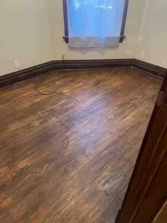 a view of a room with wooden floor
