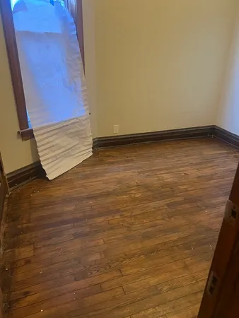 a view of room with wooden floor