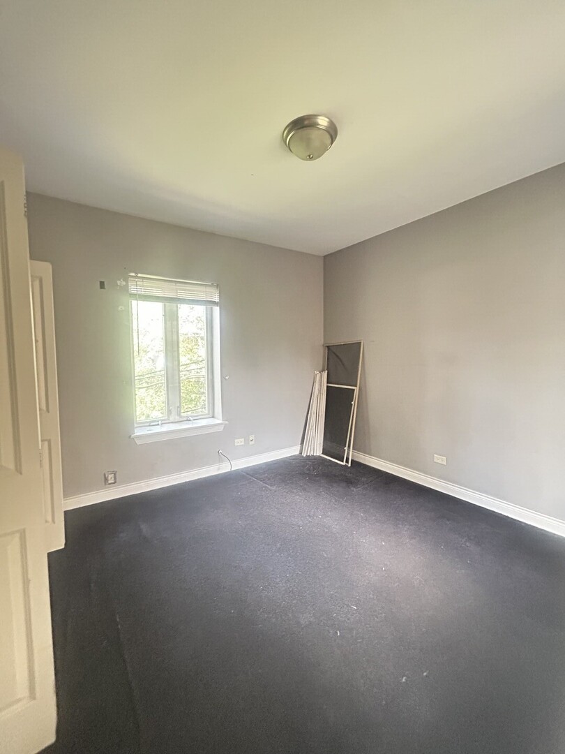 1464 East 69th Street, Unit 2N Chicago, IL 60637 - Photo 11 of 15 an empty room with a window
