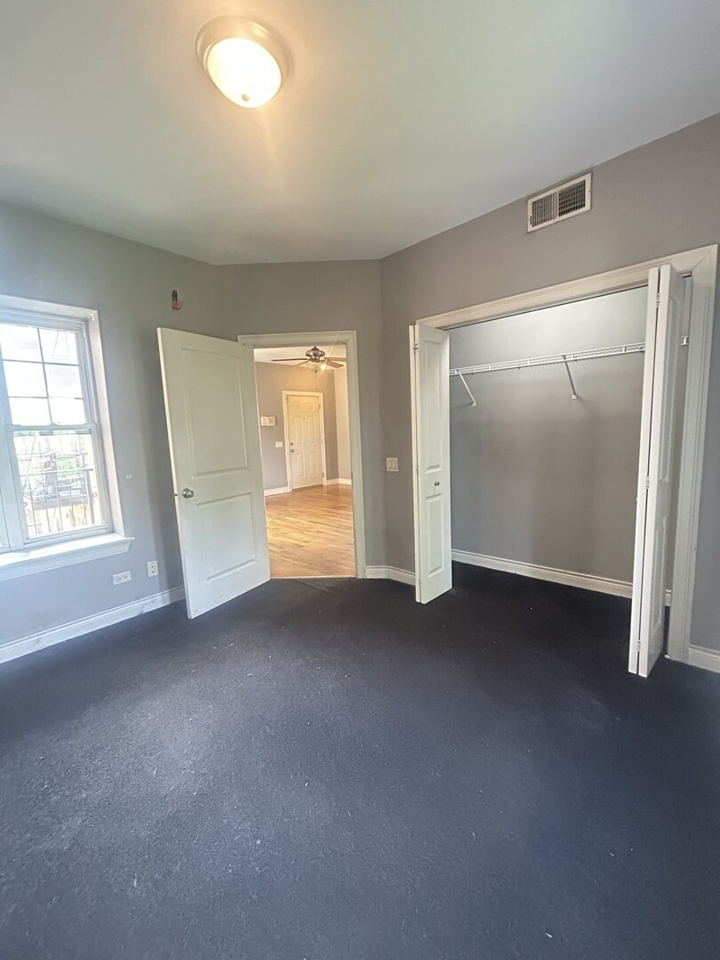 1464 East 69th Street, Unit 2N Chicago, IL 60637 - Photo 13 of 15 an empty room with windows