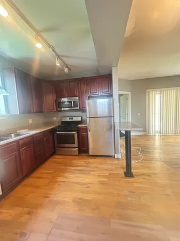 a kitchen with granite countertop a refrigerator and a stove