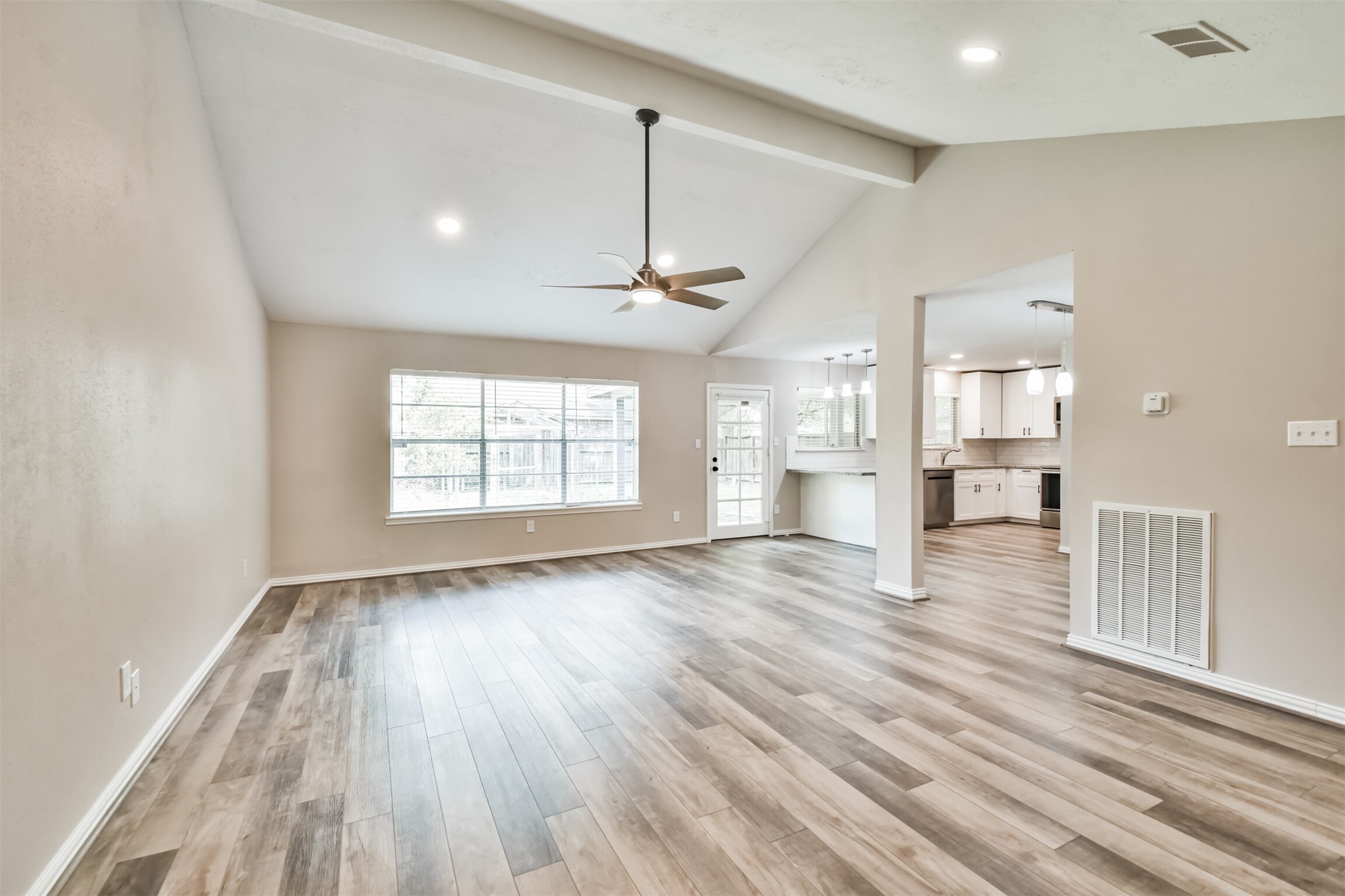 6103 Fallengate Drive Spring, TX 77373 - Photo 12 of 36 a view of an empty room with wooden floor and a window
