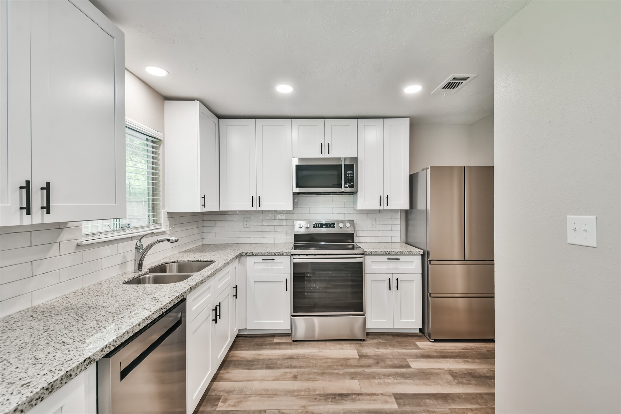 6103 Fallengate Drive Spring, TX 77373 - Photo 16 of 36 a kitchen with a sink stove and refrigerator