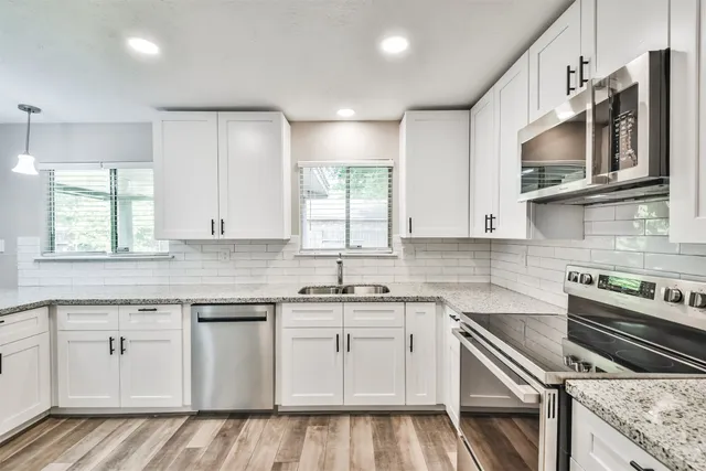 a kitchen with a sink cabinets and window