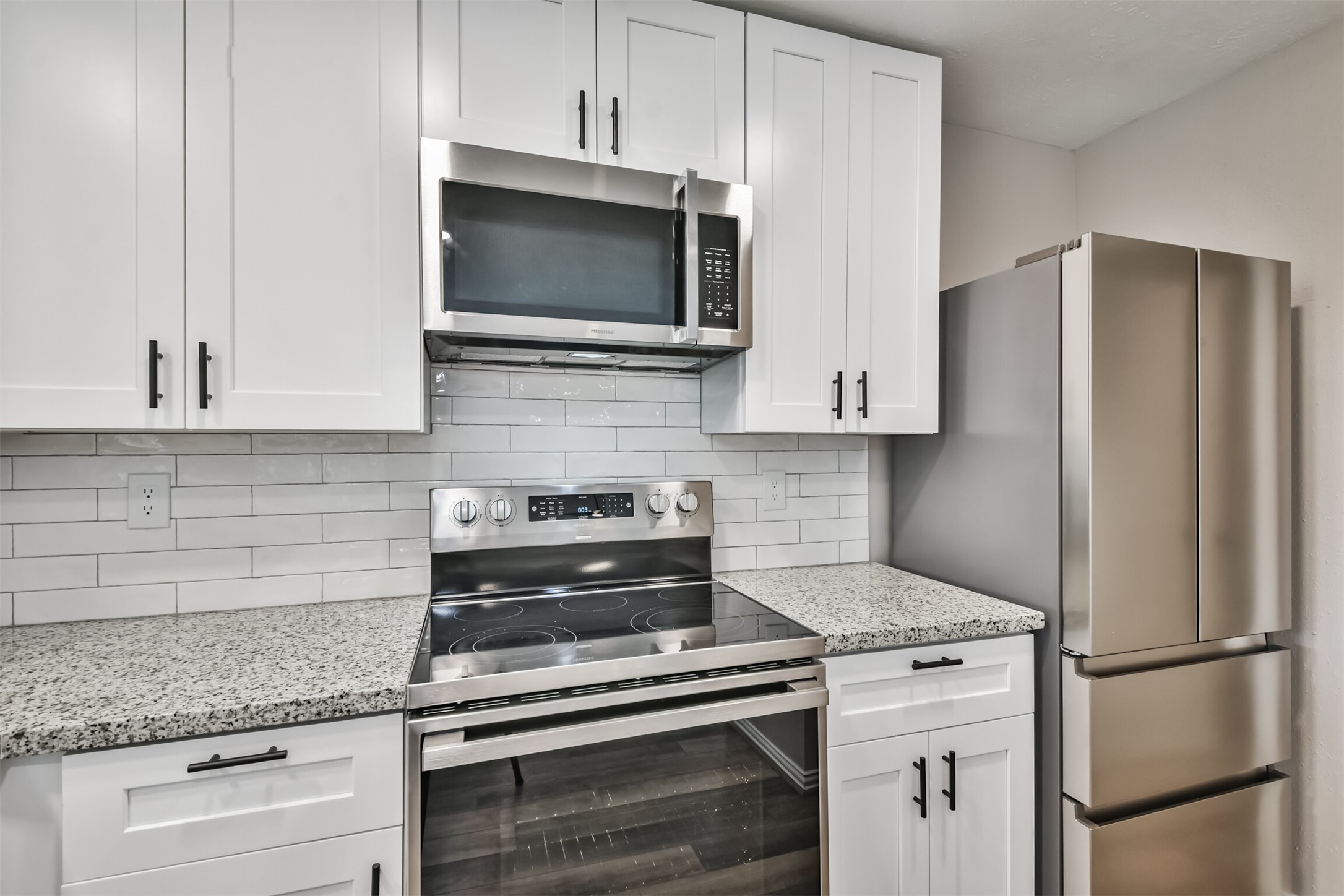 6103 Fallengate Drive Spring, TX 77373 - Photo 21 of 36 a kitchen with stainless steel appliances white cabinets and a granite counter top