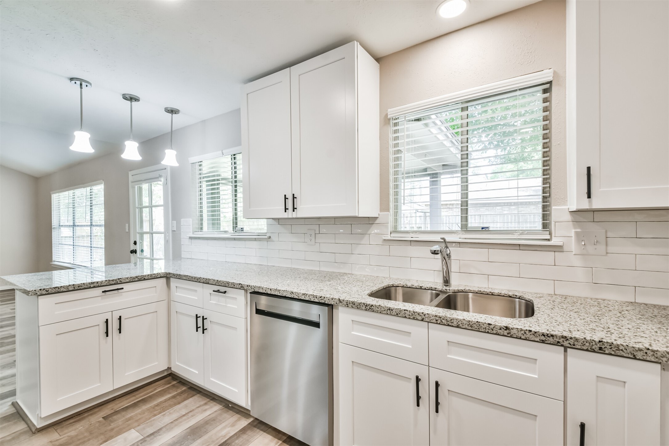 6103 Fallengate Drive Spring, TX 77373 - Photo 22 of 36 a kitchen with granite countertop white cabinets white appliances and a sink