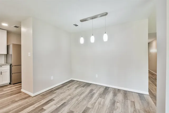 a view of a room with wooden floor and staircase