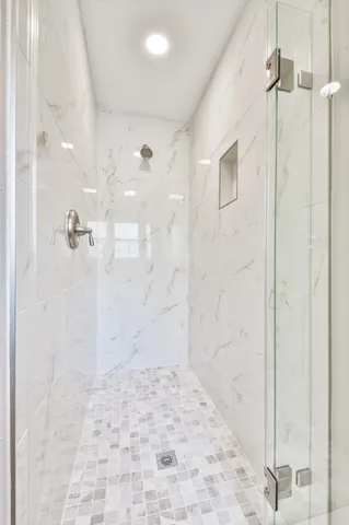 an empty room with a ceiling fan and a window